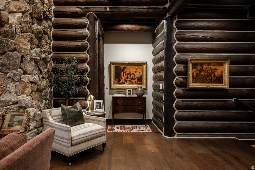 Hardwood flooring complementing log wall construction and stacked stone accent wall