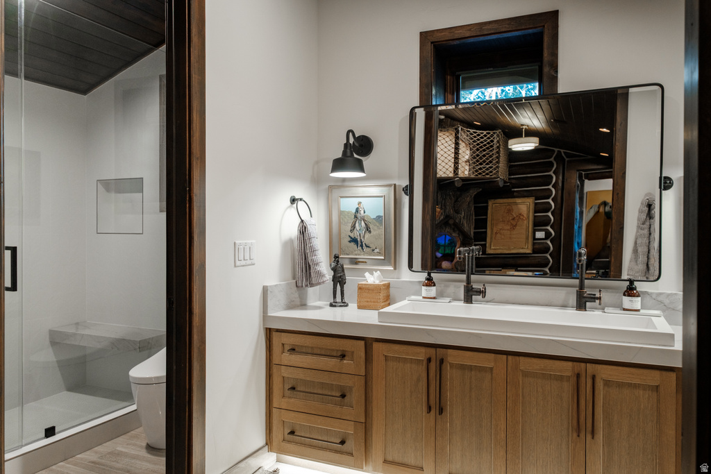 Contemporary bathroom featuring a light wood-finish double vanity with a rectangular integrated sink, matte black hardware, and a framed mirror