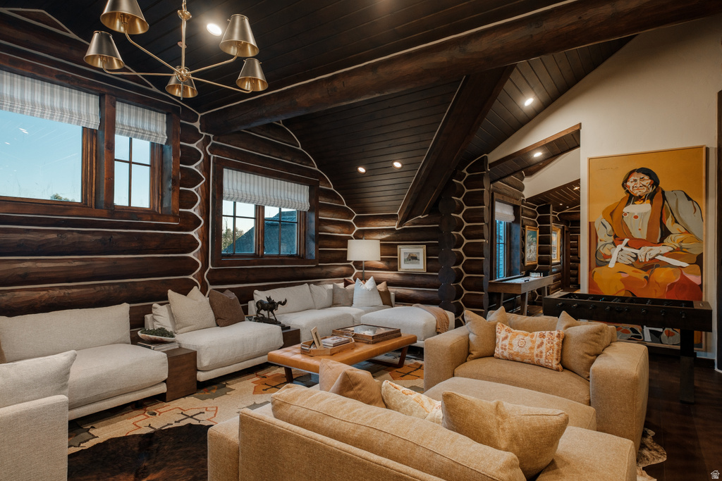 Spacious living area featuring log walls, exposed wood beams, and dark wood-finish flooring