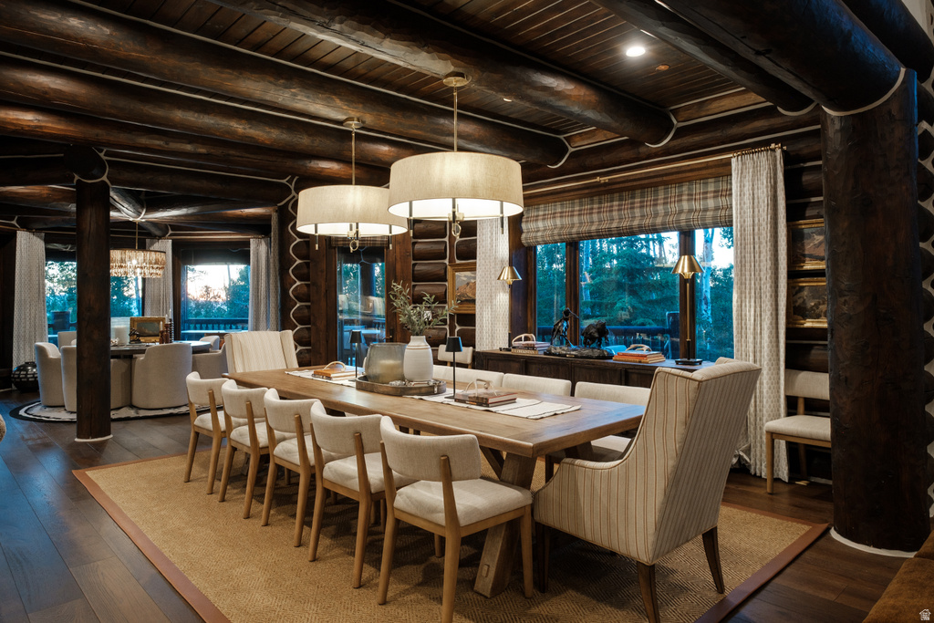 Expansive dining area featuring a light wood-finish table, recessed lighting, and dual pendant lighting fixtures
