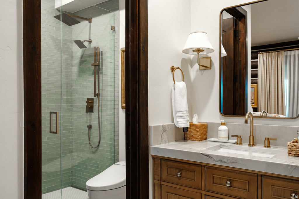 Bathroom featuring a glass-enclosed shower with subway tile, rainfall showerhead, and a separate handheld shower