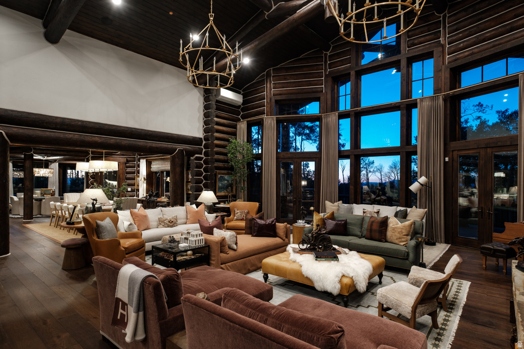 Grand living area featuring soaring ceilings and dark wood-finish flooring
