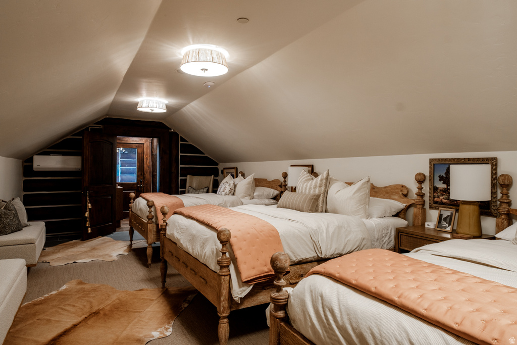 Attic space featuring sloped ceilings and exposed wood beams