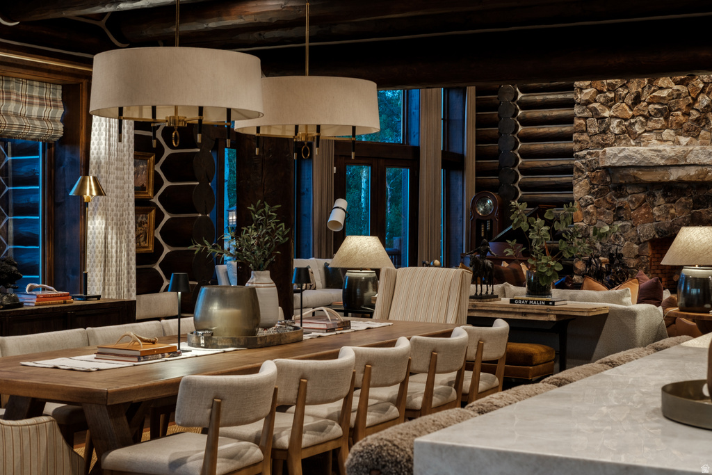 Spacious dining area featuring a long wooden table and upholstered chairs