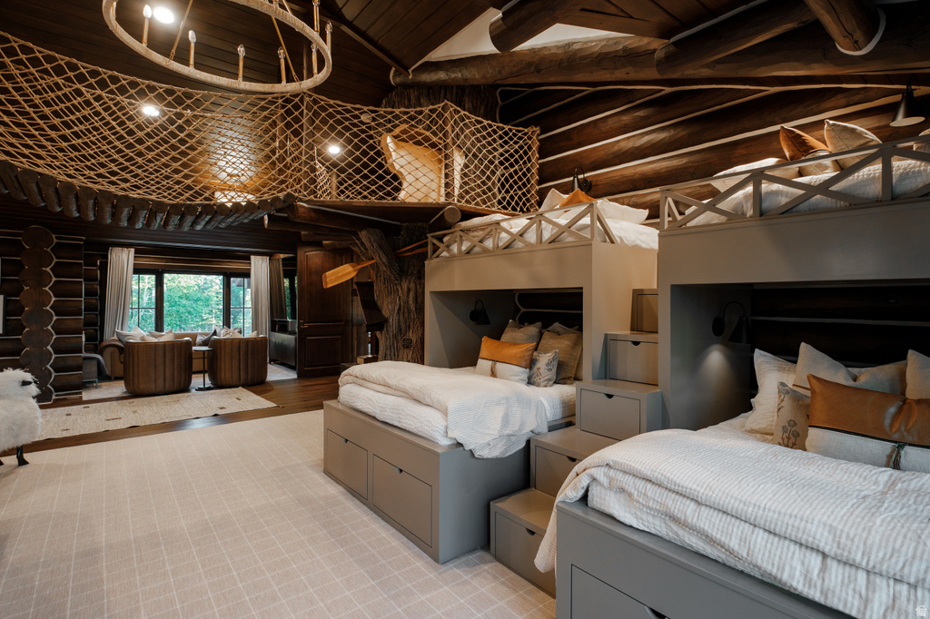 Custom-built bunk beds with integrated storage and steps, under a rustic exposed beam ceiling