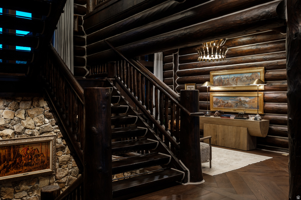 Expansive wooden staircase with carved balusters and a dark wood-finish
