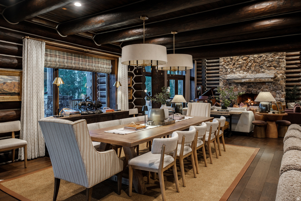 Spacious dining area featuring a long wood table and upholstered seating