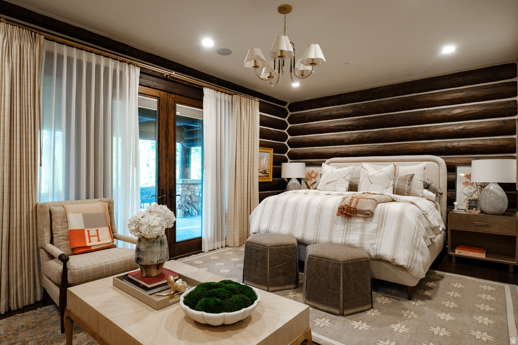 Expansive room featuring log walls, recessed lighting, and a chandelier
