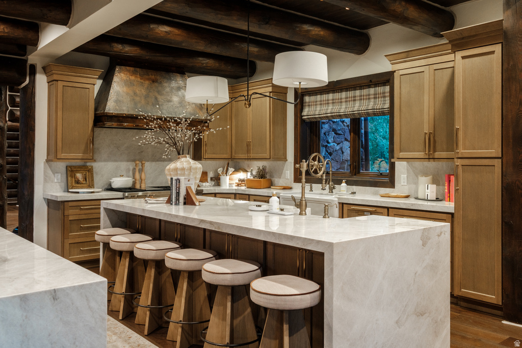 Expansive kitchen island featuring a waterfall countertop