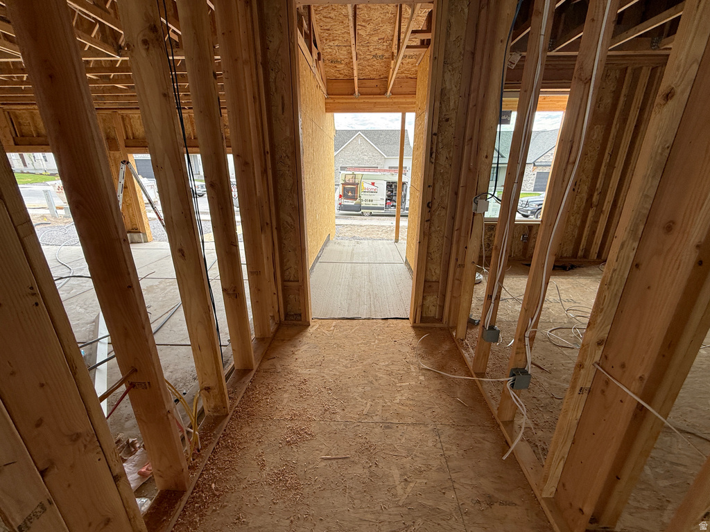 New construction framing with exposed wooden studs, oriented strand board subflooring, and pre-wired electrical