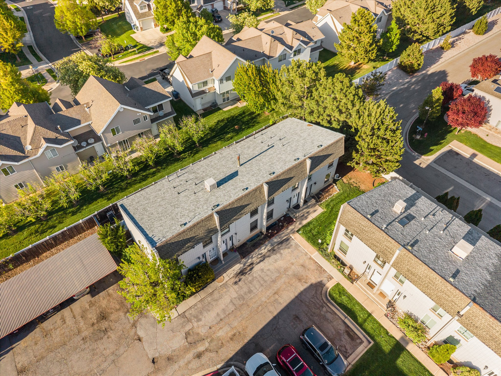 Aerial perspective showcasing a multi-unit residential property with a shingle roof and light-colored exterior