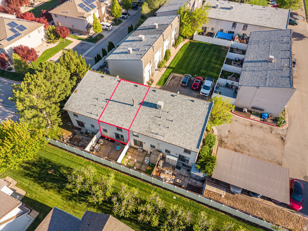 Aerial perspective showcasing a multi-unit property with a light grey roofing system