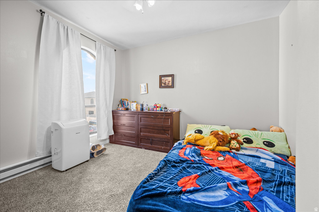 Carpeted room with light gray walls and an arched window