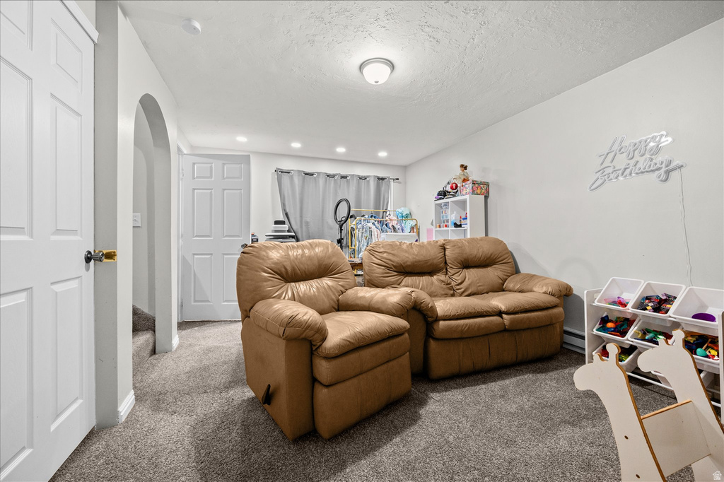 Finished living space featuring gray carpet flooring, white walls, and recessed lighting