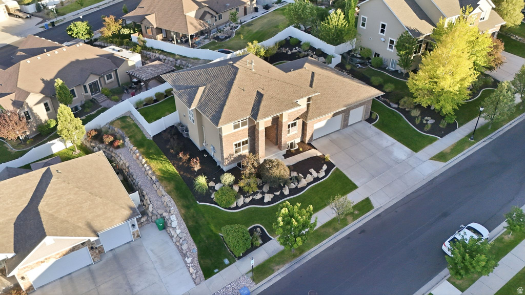 Two-story residential property featuring a multi-gable roofline, a two-car garage, and a concrete driveway