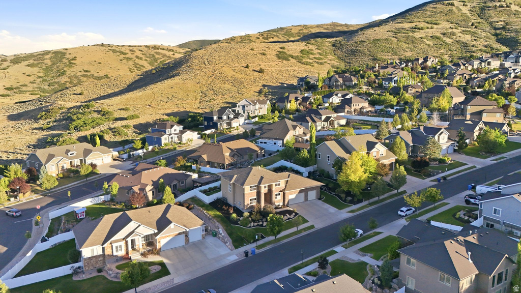Residential neighborhood featuring single-family homes with pitched roofs, attached garages, and landscaped yards