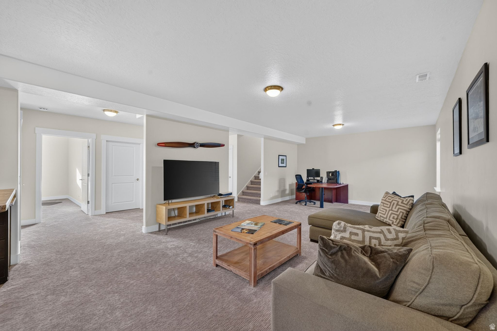 Spacious carpeted room featuring recessed lighting and a neutral color palette