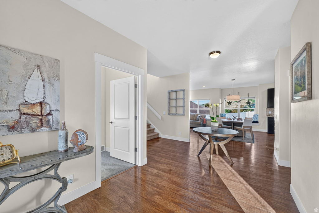 Open-concept interior featuring wood-finish flooring, neutral wall tones, and recessed lighting