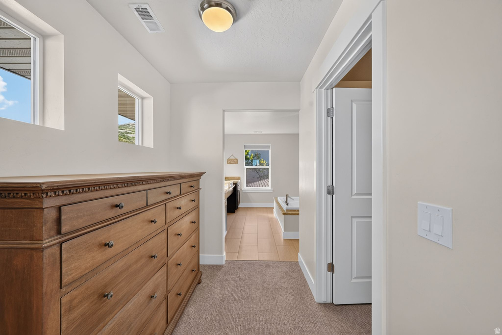 Hallway with neutral wall paint, recessed lighting, and carpeted flooring