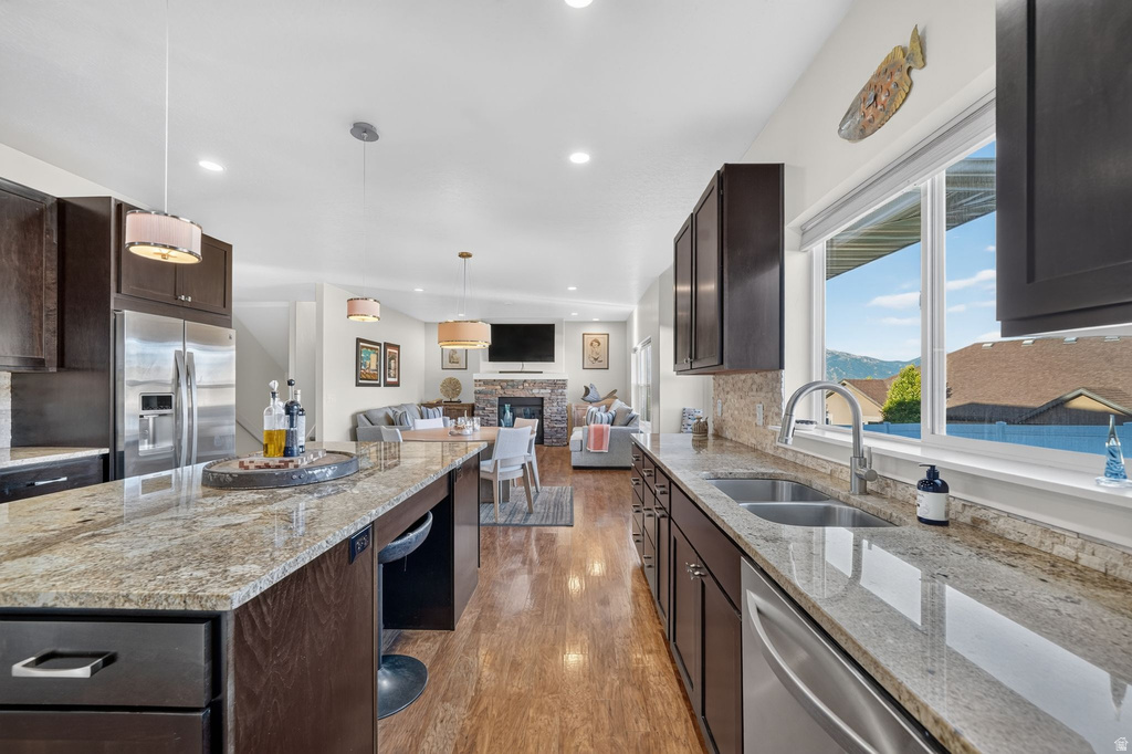 Kitchen featuring granite countertops, dark wood-finish cabinetry, and stainless steel appliances