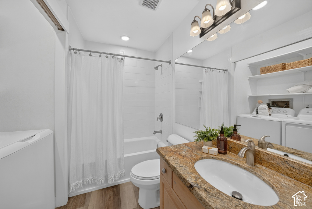 Bathroom featuring a single vanity with a granite-finish countertop, undermount sink, and brushed nickel faucet