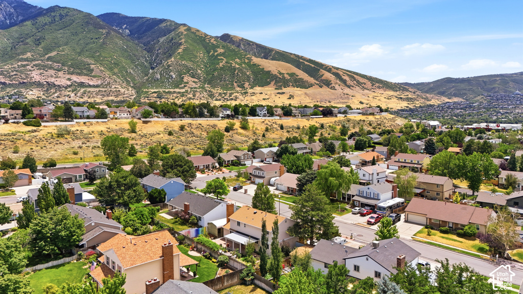 Residential neighborhood situated against a backdrop of verdant mountains and foothills