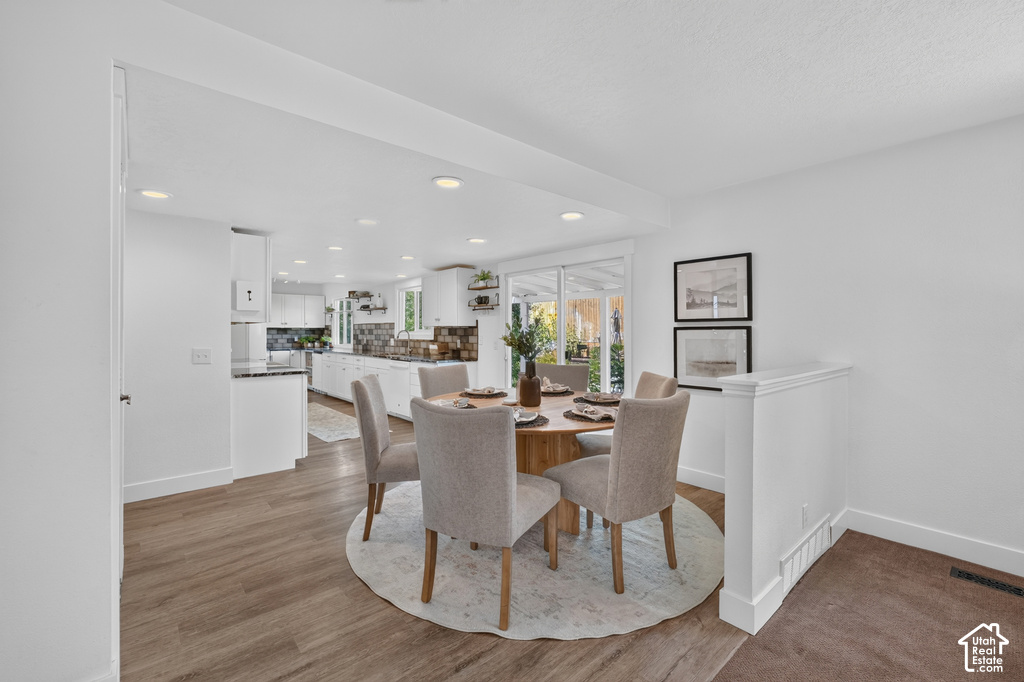 Dining area featuring wood-finish flooring and recessed lighting