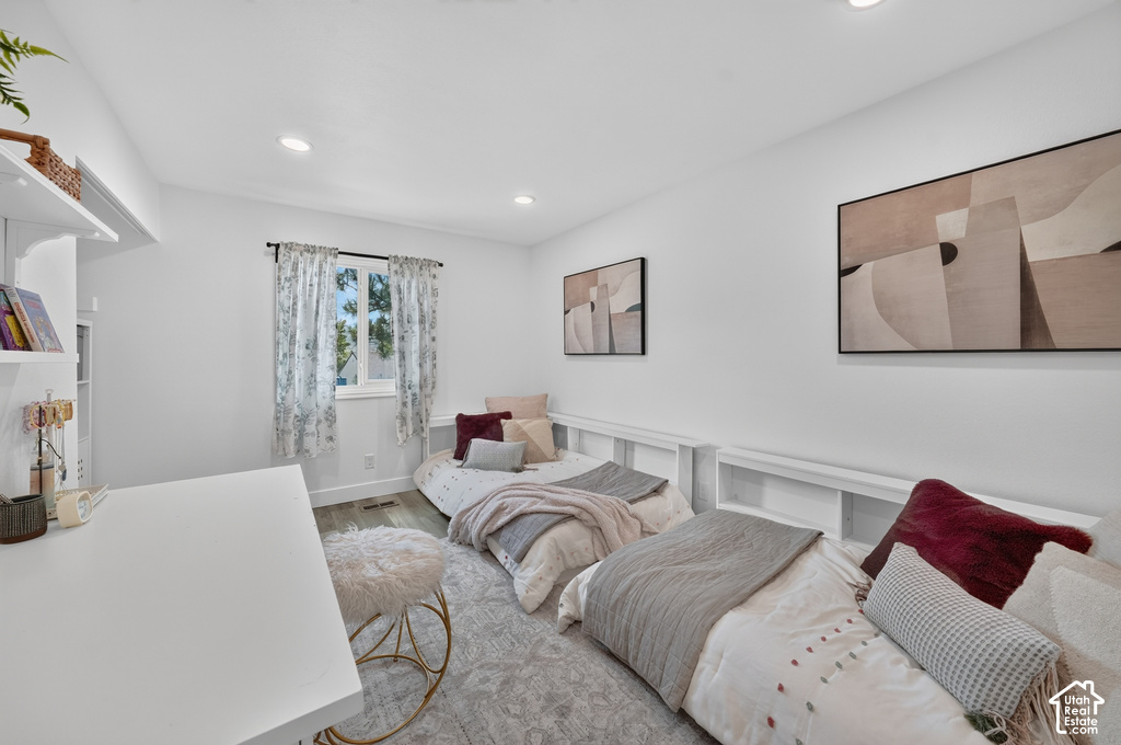 Bright interior room featuring wood-finish flooring and recessed lighting