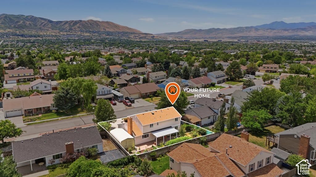 Aerial perspective showcasing a two-story residence with a light-colored exterior and a prominent orange roof