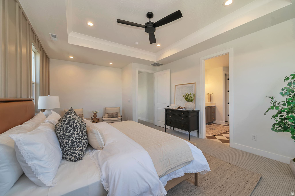 Bedroom featuring a tray ceiling with recessed lighting and a ceiling fan, plush carpet flooring, and an accent wall with vertical paneling