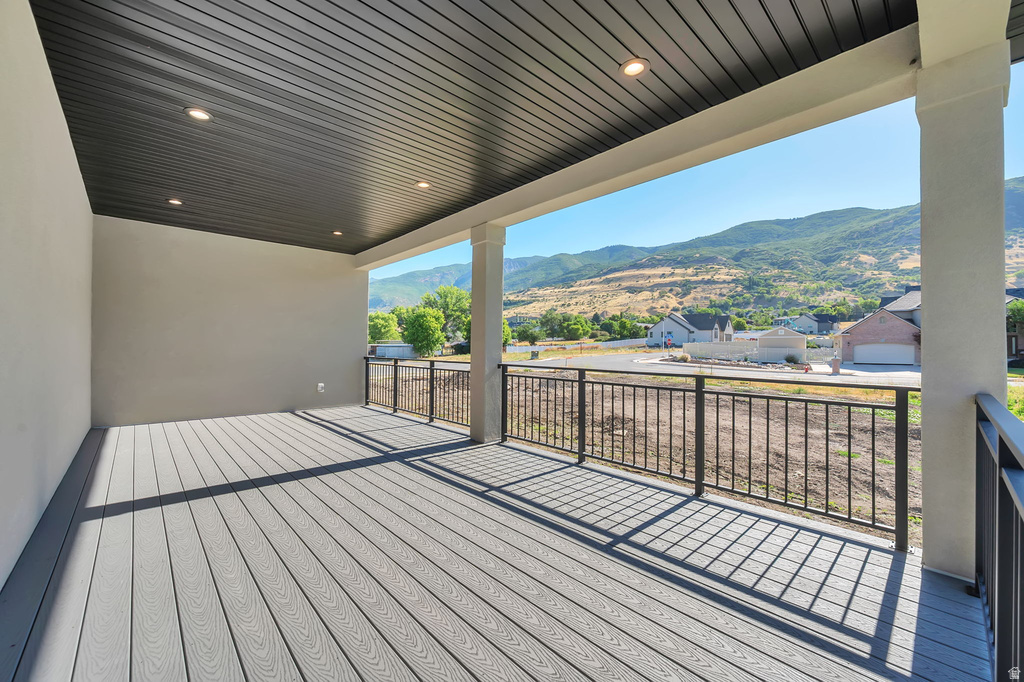 Covered outdoor deck with grey wood-finish flooring