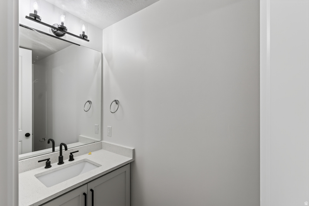 Modern vanity with an integrated sink, quartz-finish countertop, and matte black hardware