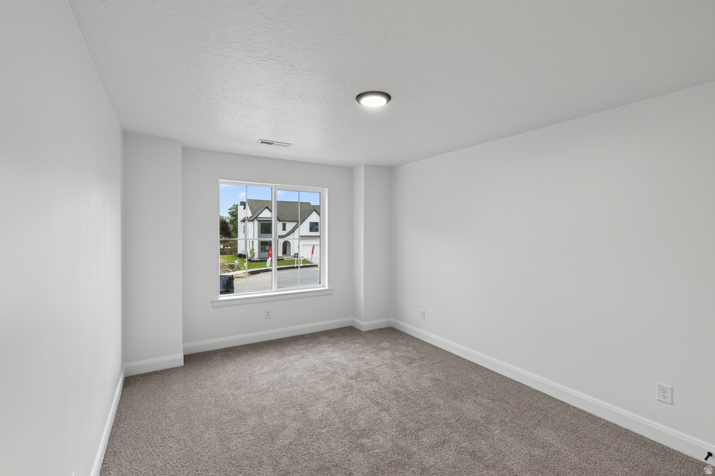 Room featuring neutral carpet, white walls, and a window with white trim