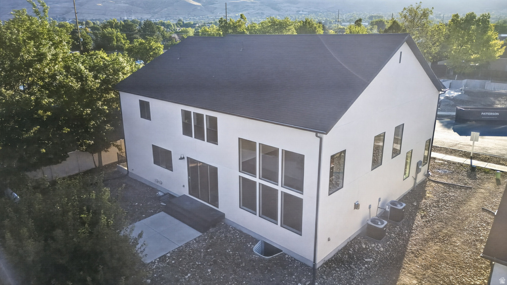 Contemporary white exterior featuring a dark asphalt shingle roof