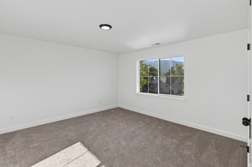 Neutral-toned wall-to-wall carpeting and crisp white walls
