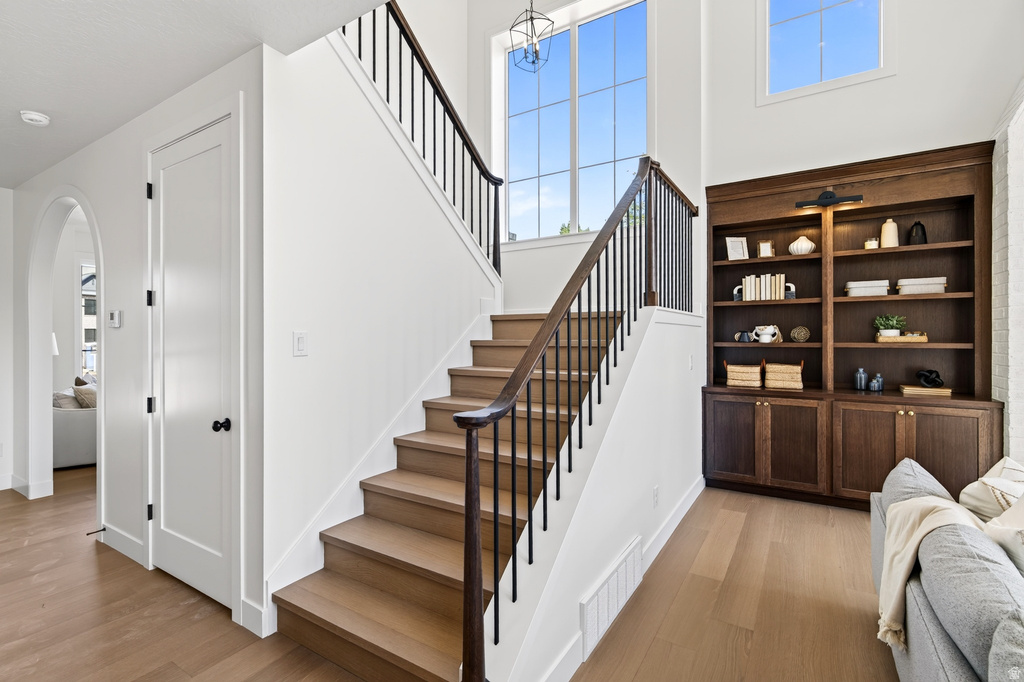 Open staircase with wood-finish treads and black metal balusters