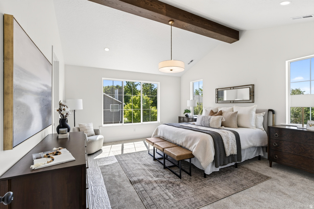 Vaulted ceiling with an exposed wood beam, large picture windows, recessed lighting, and soft carpet flooring