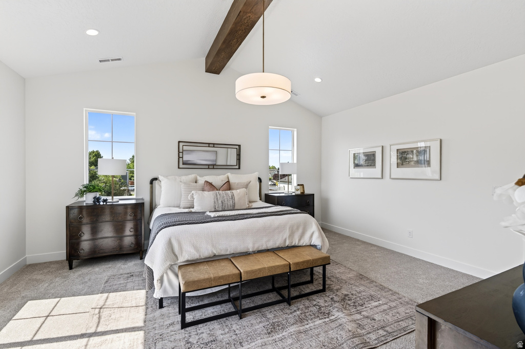 Vaulted ceiling featuring an exposed wood beam and a contemporary drum pendant light