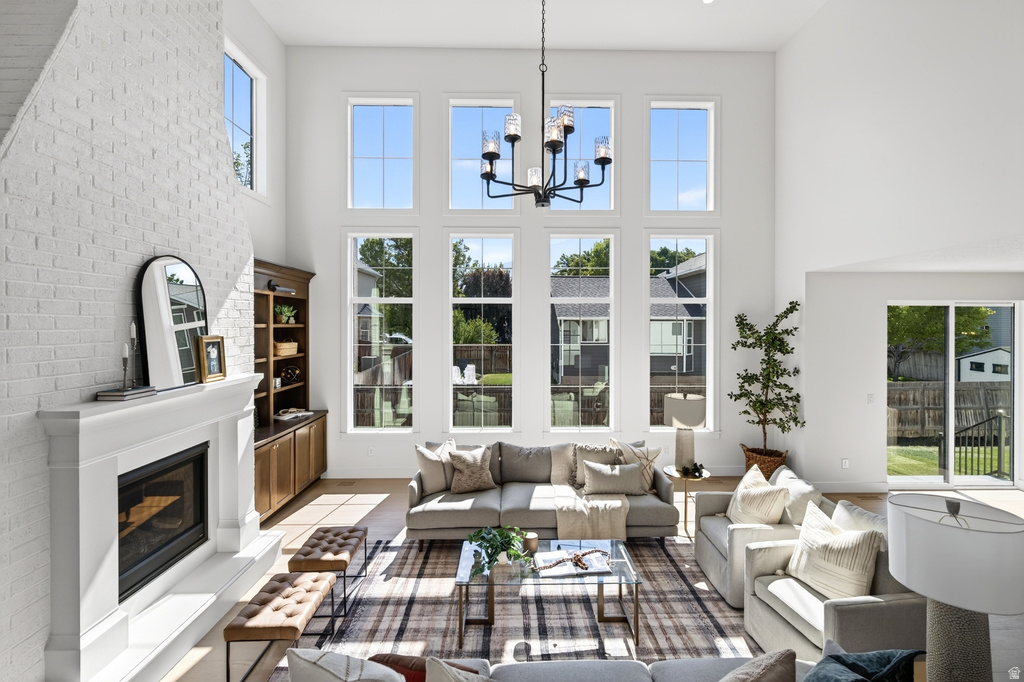Vaulted living space with a white brick fireplace and built-in shelving
