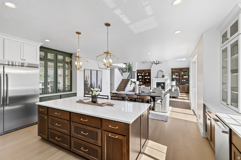 Expansive kitchen island with a white countertop and wood-finish cabinetry