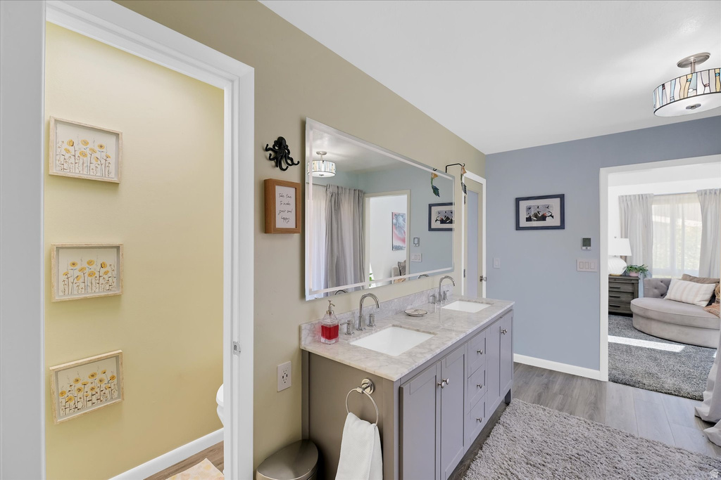 Dual vanity with undermount sinks, stone-finish countertop, and chrome fixtures