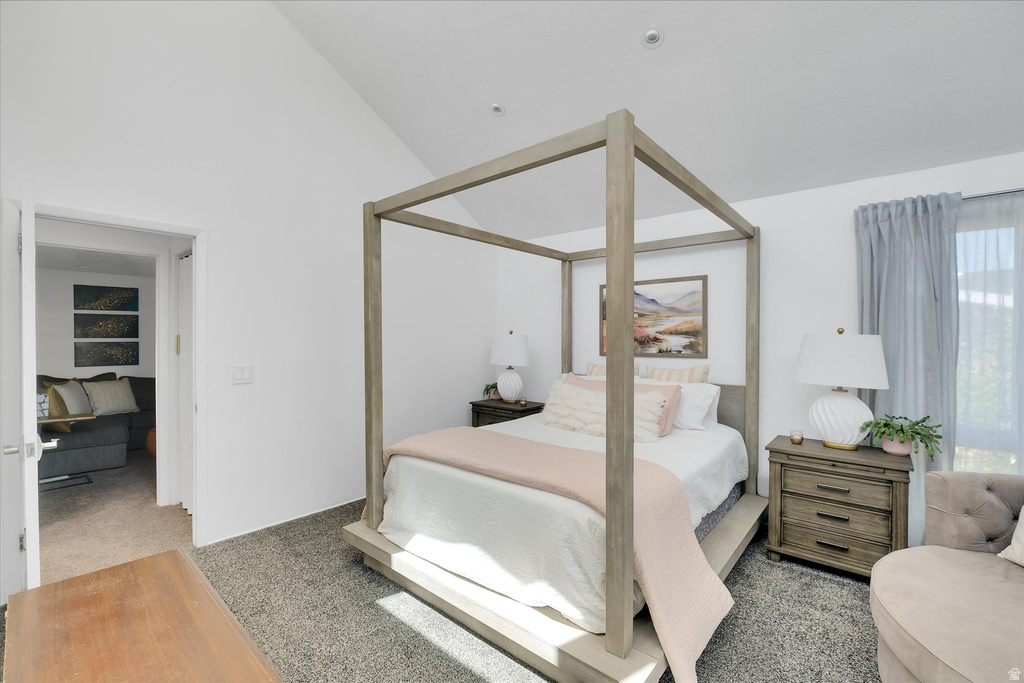 Vaulted ceiling room with wood-finish flooring