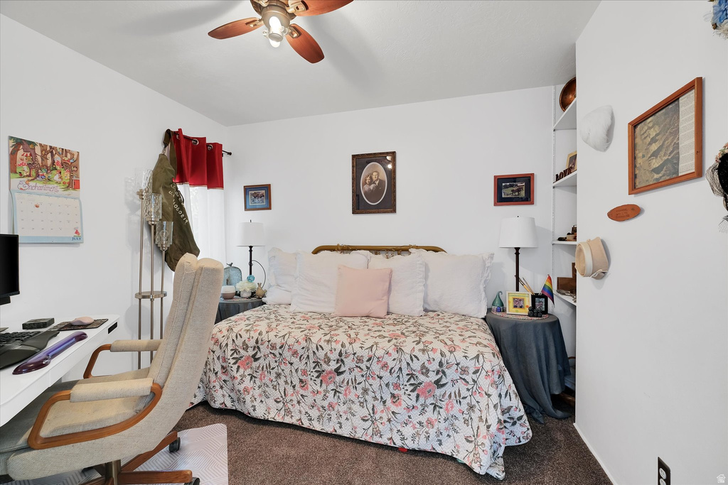 Bedroom featuring white walls and textured carpeting