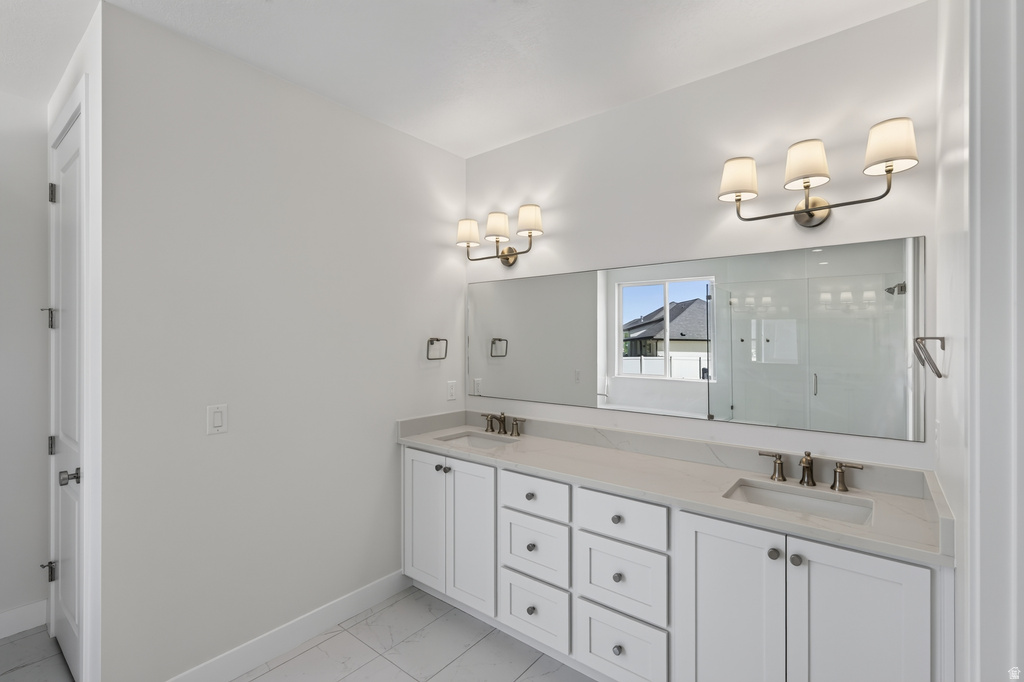 Dual vanity with white cabinetry, light-colored countertops, and undermount sinks