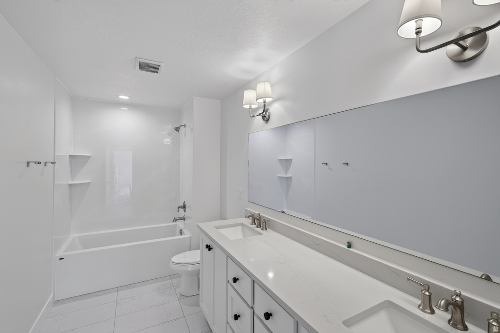 Dual vanity with undermount sinks, stone-finish countertop, and brushed nickel fixtures
