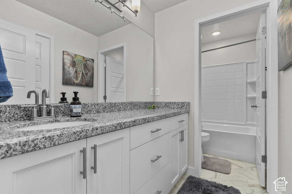 Spacious vanity featuring a granite-finish countertop, single undermount sink, and brushed nickel faucet