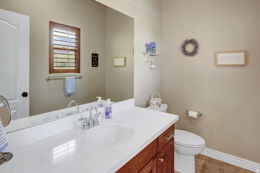 Bathroom featuring a white quartz countertop, integrated oval sink, and chrome faucet