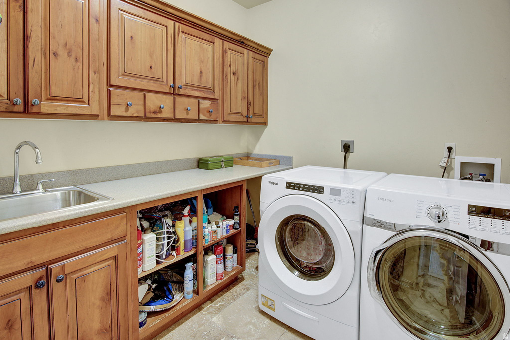 Laundry area featuring extensive wood cabinetry, a stainless steel sink with a high-arc faucet, ample countertop space, and open shelving
