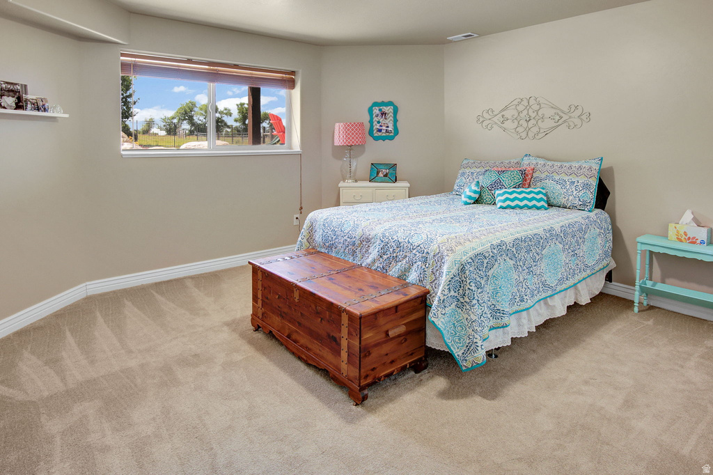 Carpeted room featuring a white-framed window, a built-in floating shelf, and neutral wall paint