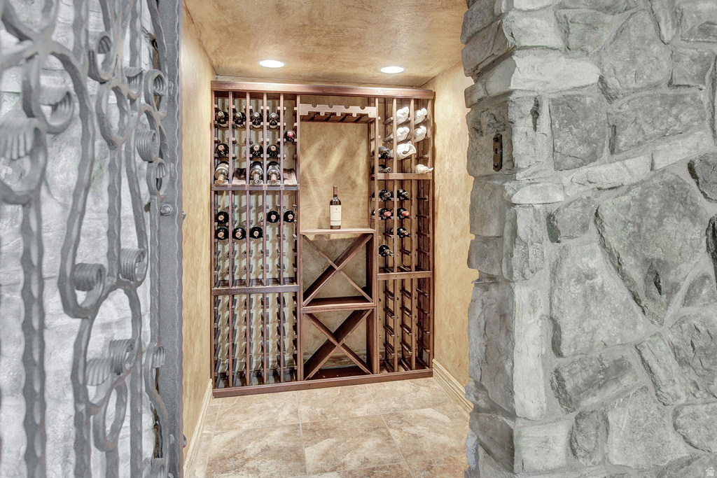 Dedicated wine cellar featuring extensive wood-finish storage, a built-in display shelf, and recessed lighting